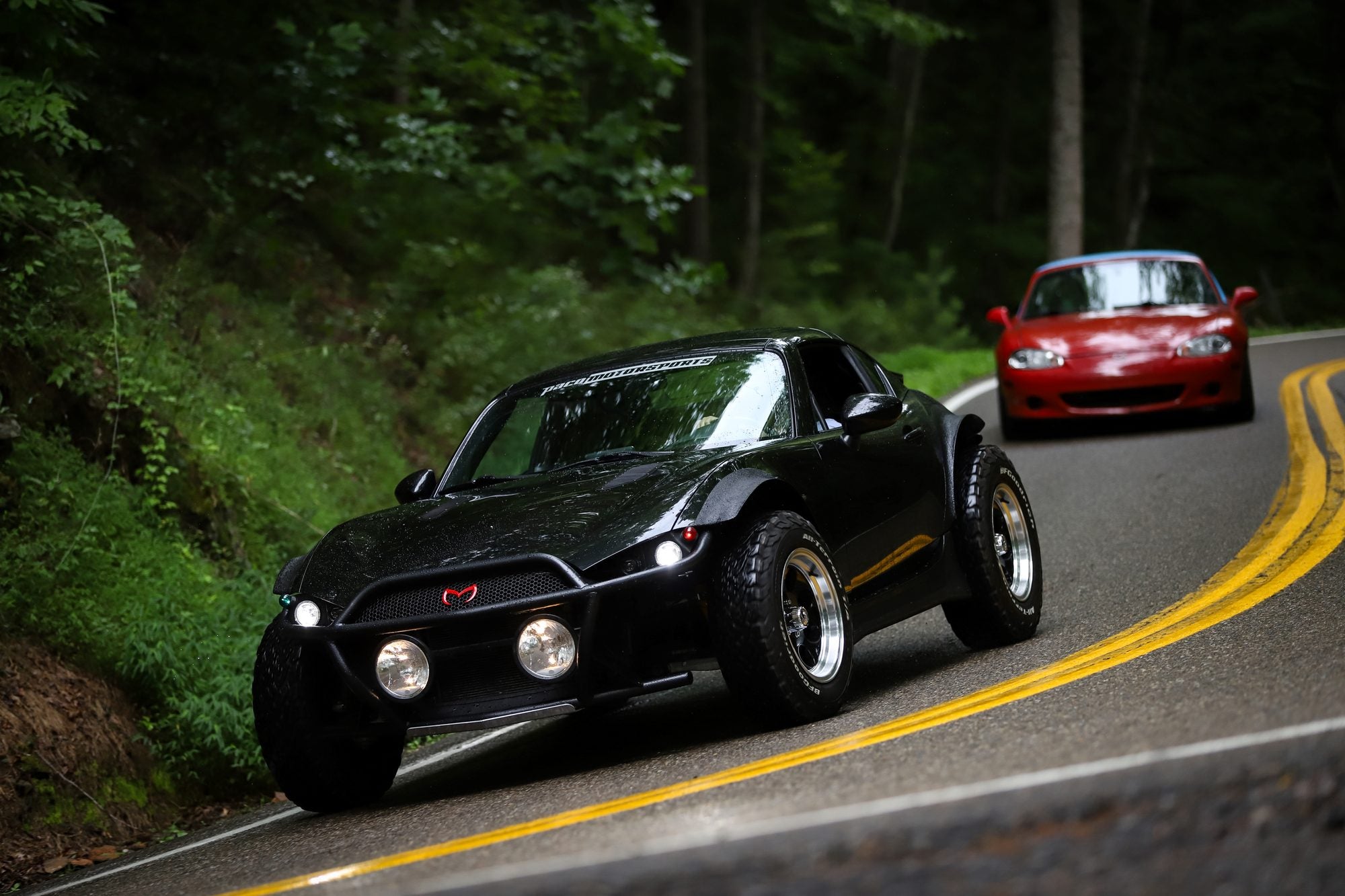 Beachster leading another Miata through a sweeping road